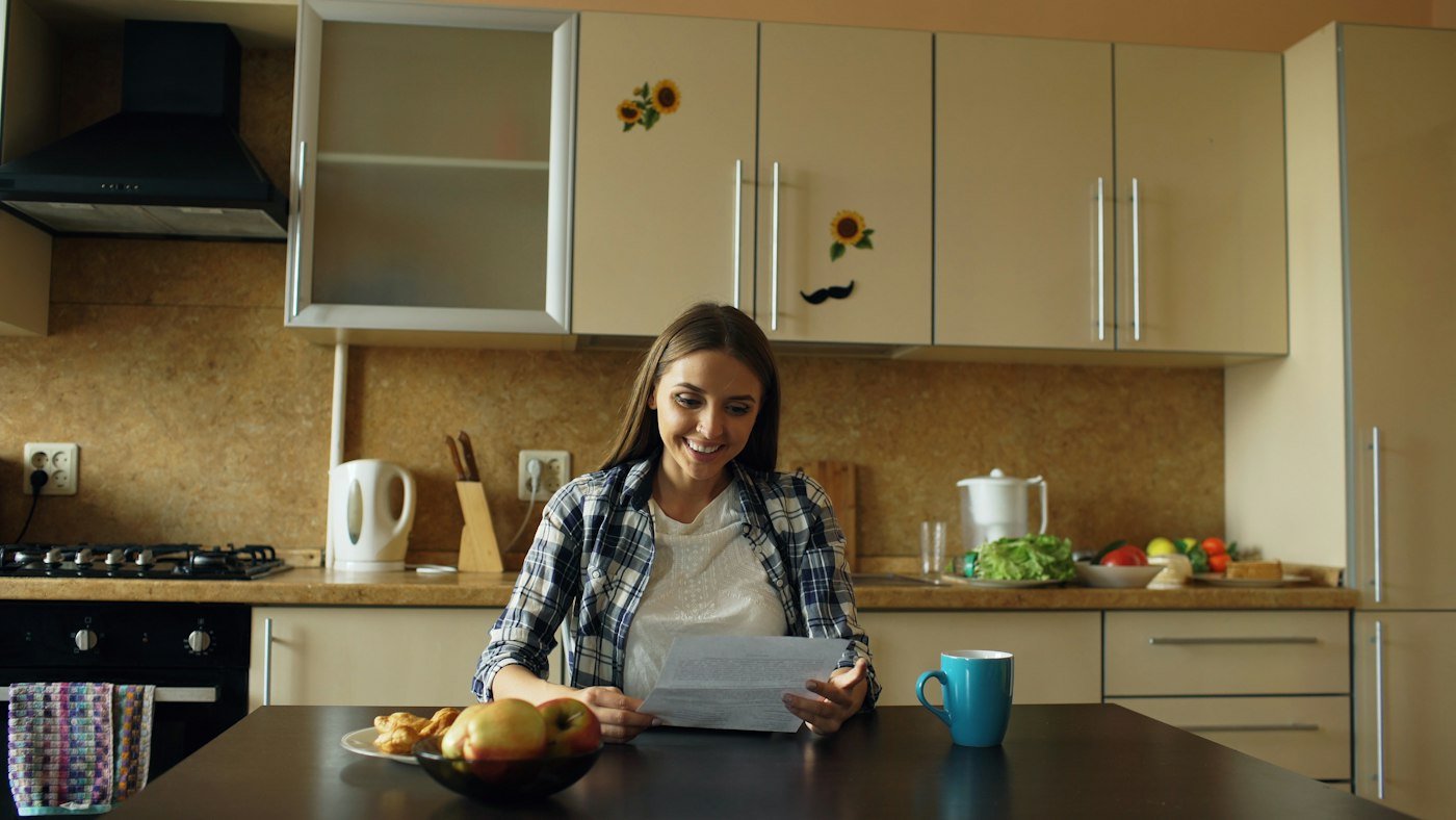 A client reading through a document at her kitchen table