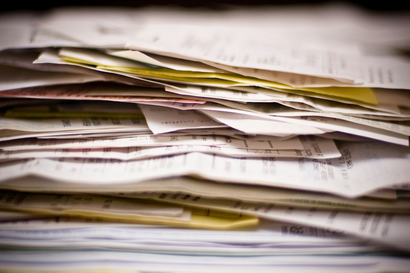 A pile of receipts, invoices and statements