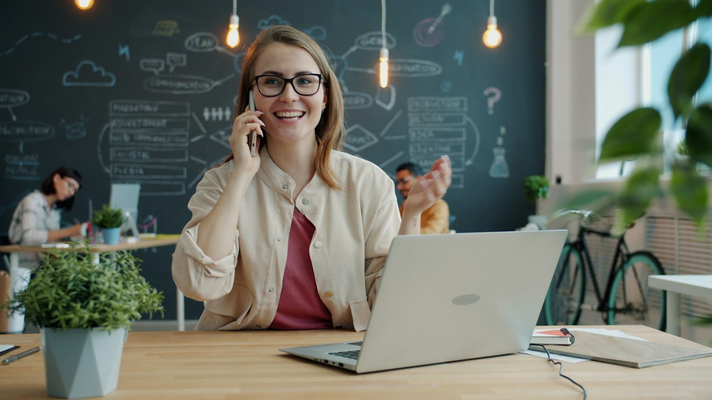 A business owner on the phone at her desk