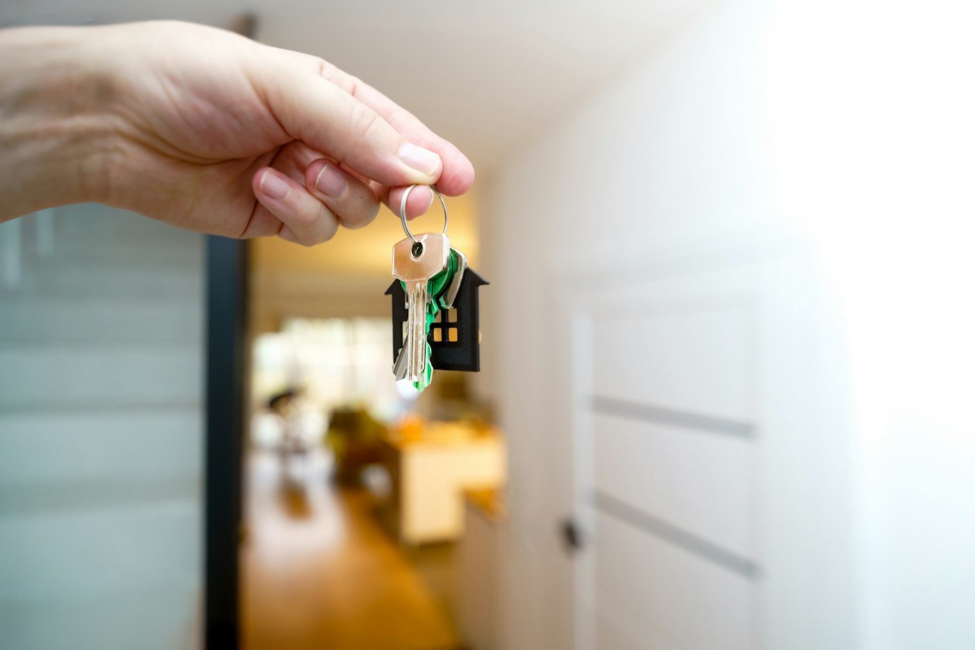 A hand holding the keys to a let property