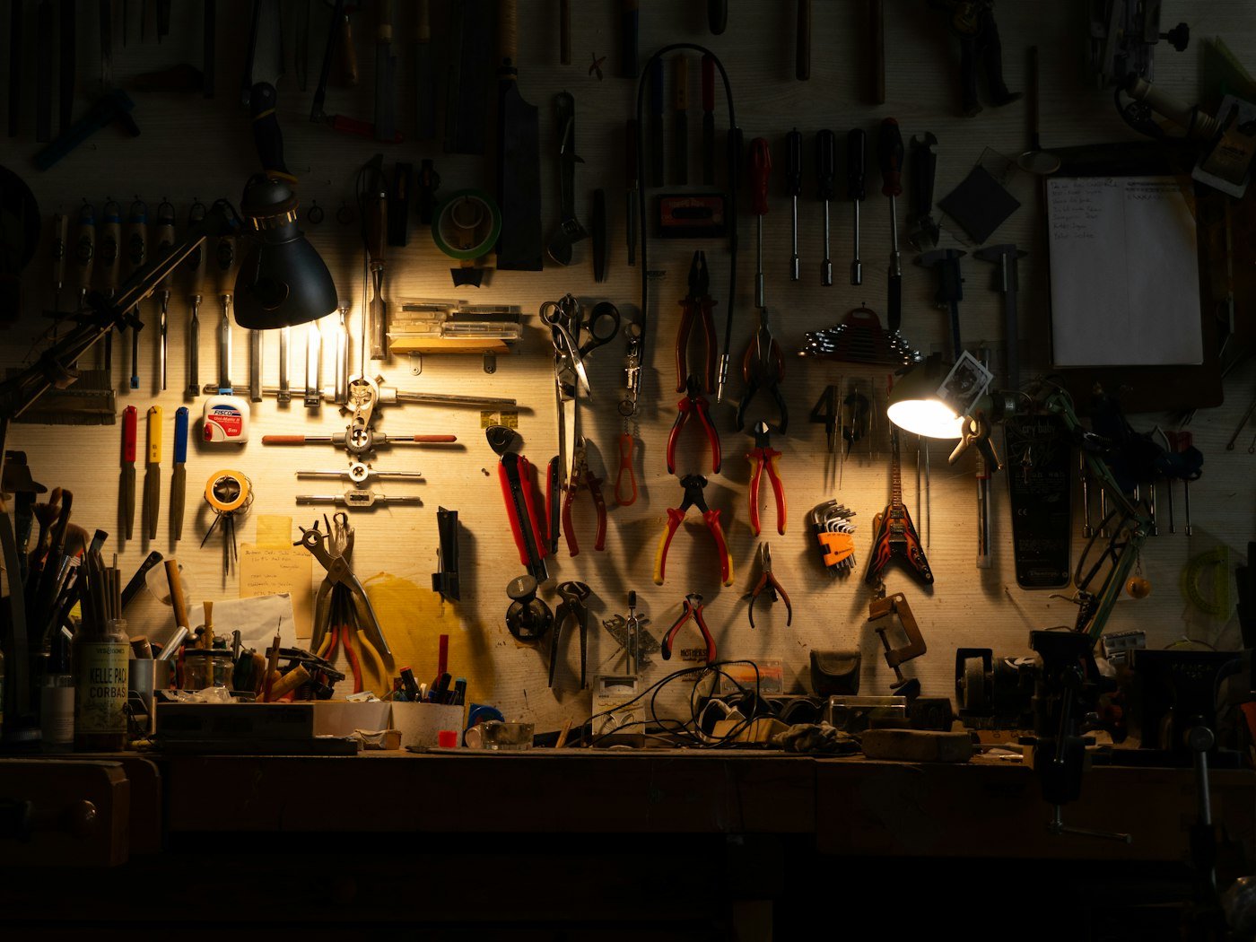 A workshop wall of tools above a tidy bench