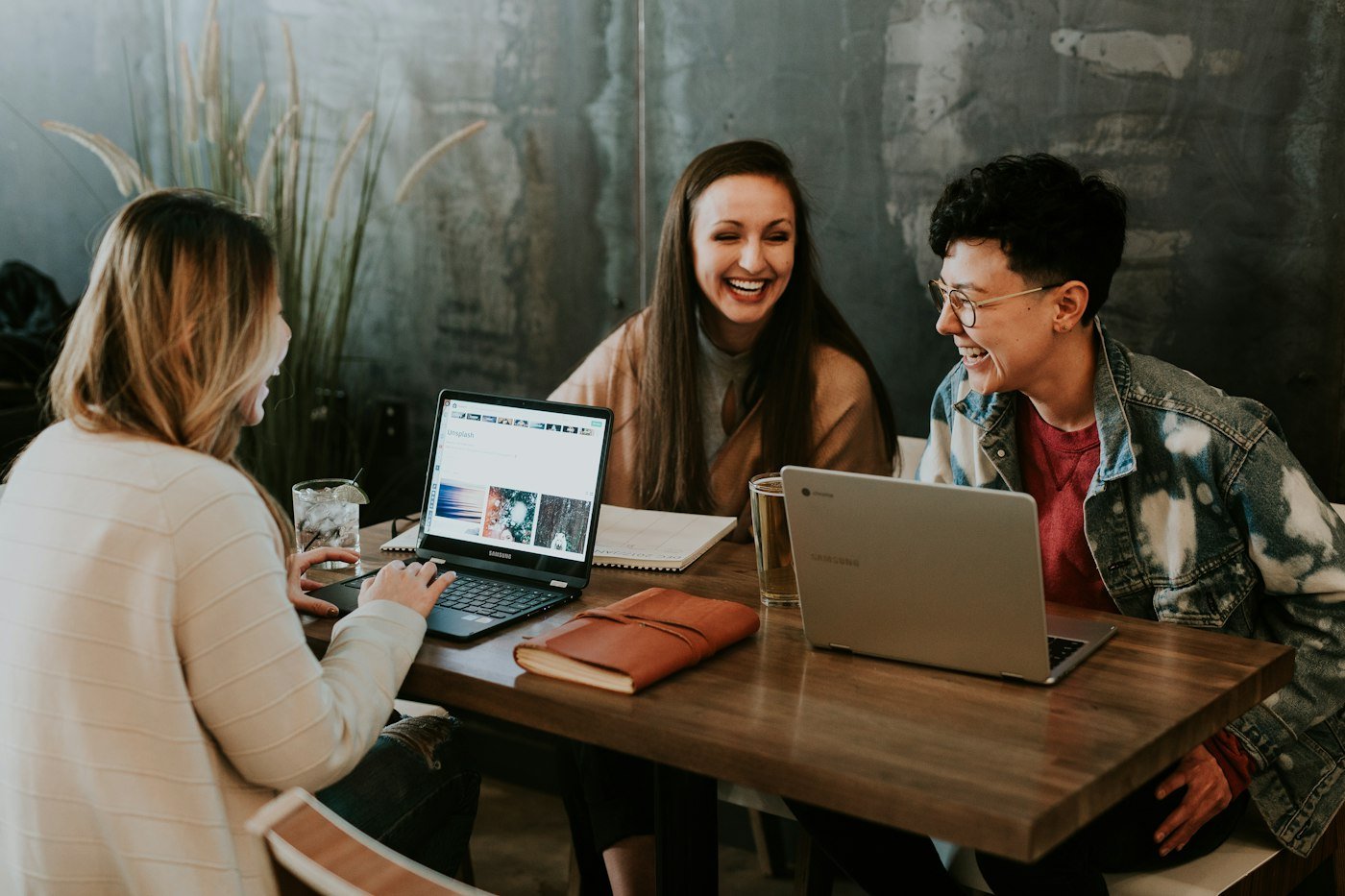 Three people running a small company around a table