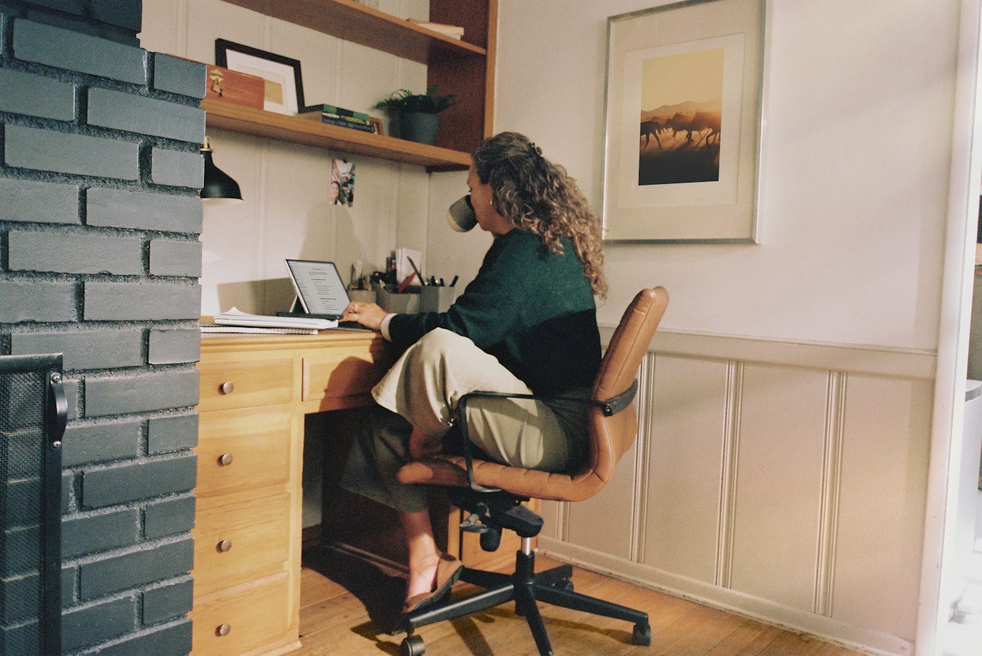 A woman working at a desk in her home office